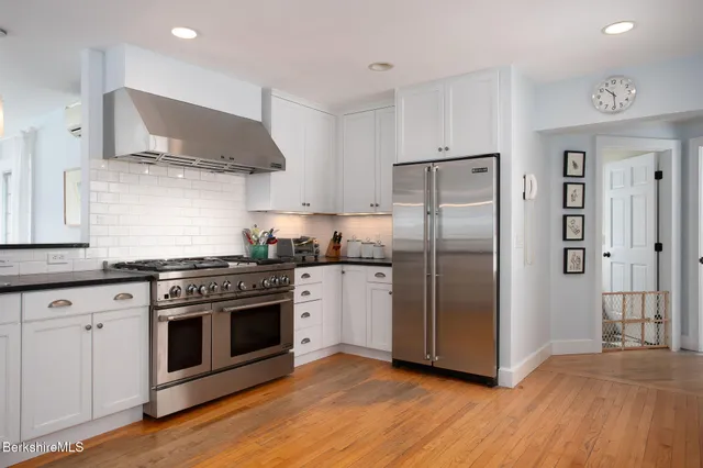 a kitchen with stainless steel appliances a stove and a refrigerator