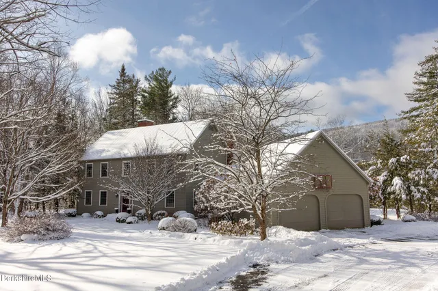 a view of a house with a snow in the yard