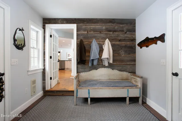 a bedroom with bed and a mirror