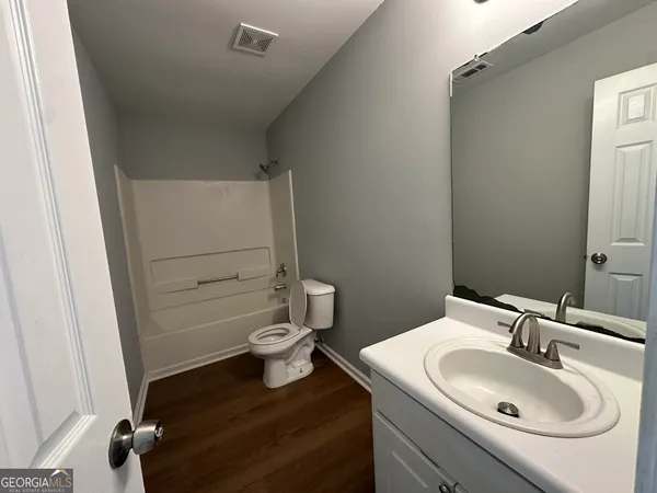 a bathroom with a sink a toilet and tub