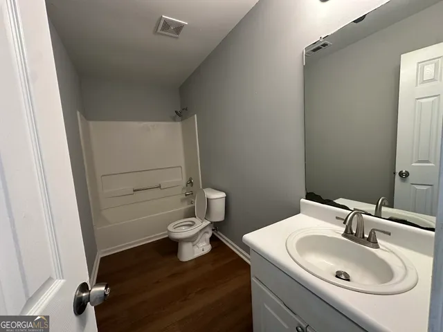 a bathroom with a sink a toilet and tub