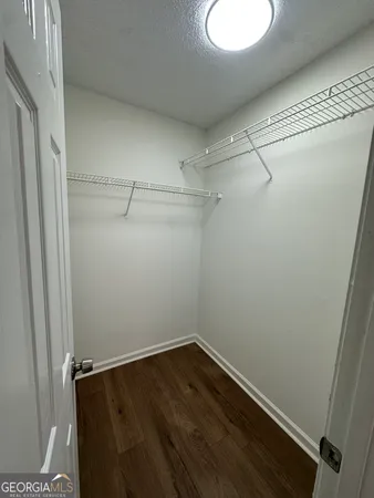 a view of a room with wooden floor