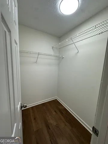 a view of a room with wooden floor