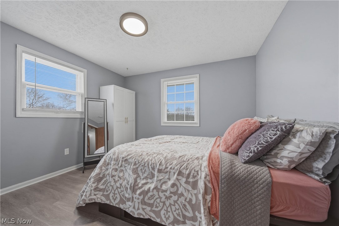 702 Perry Drive Northwest Canton, OH 44708 - Photo 23 of 46 Bedroom with a textured ceiling and wood finished floors