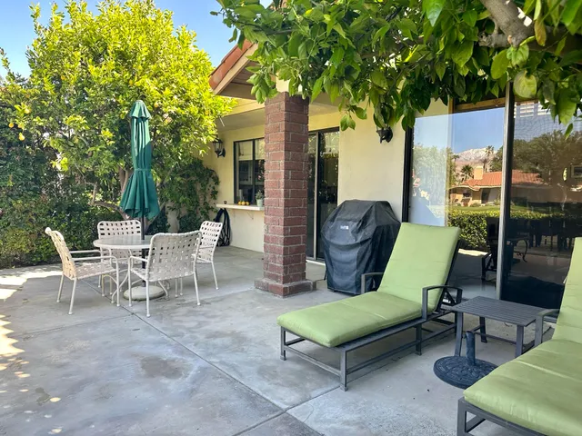 a view of a two chairs in a patio