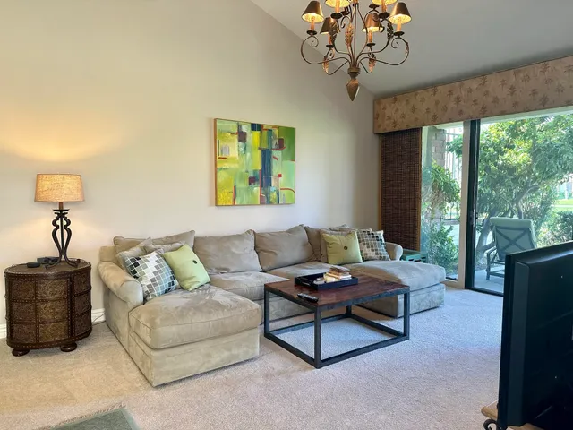 a living room with furniture a rug and a large window