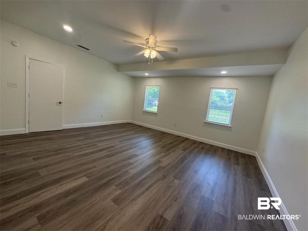 9570 Melanie Lane Semmes, AL 36575 - Photo 6 of 8 Empty room featuring a ceiling fan, dark wood-style floors, baseboards, and recessed lighting