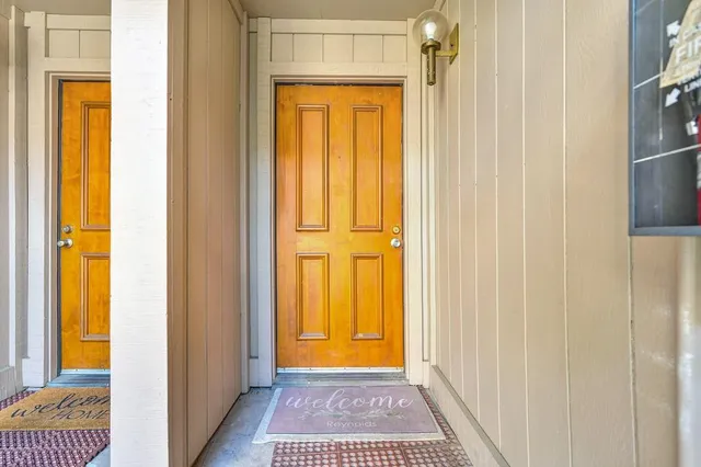 a view of a bathroom with a door and a window