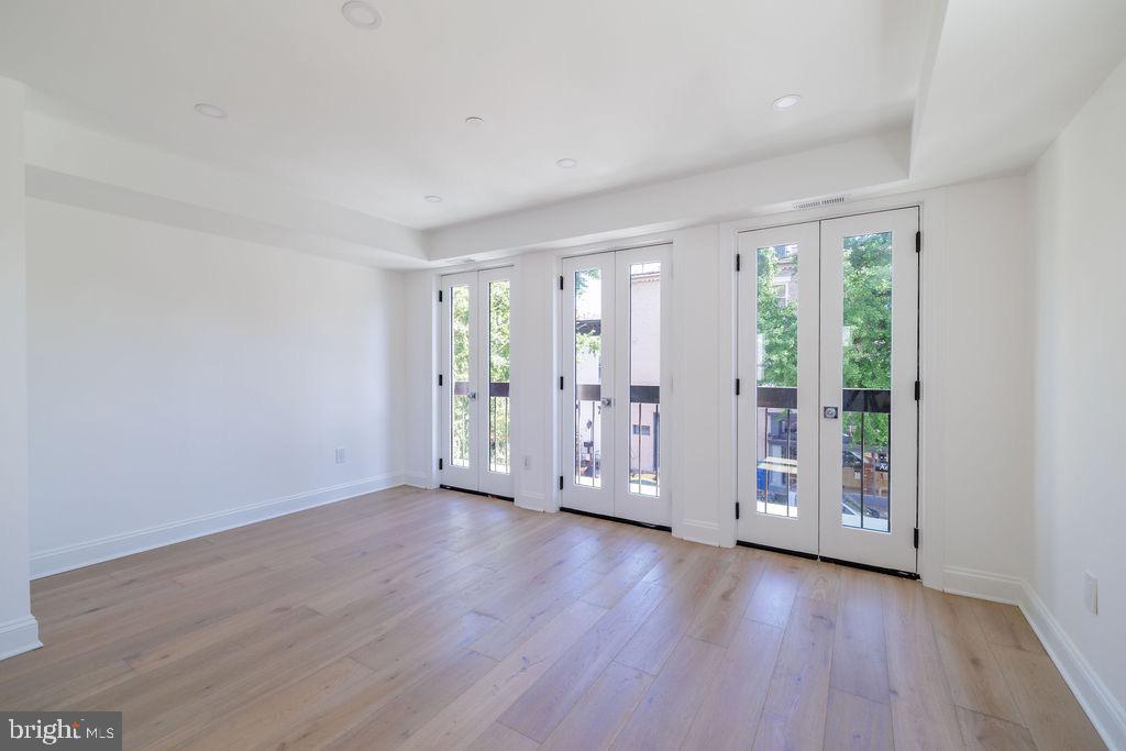 1200 Potomac Street Northwest Washington, DC 20007 - Photo 14 of 37 a view of an empty room with wooden floor and a window