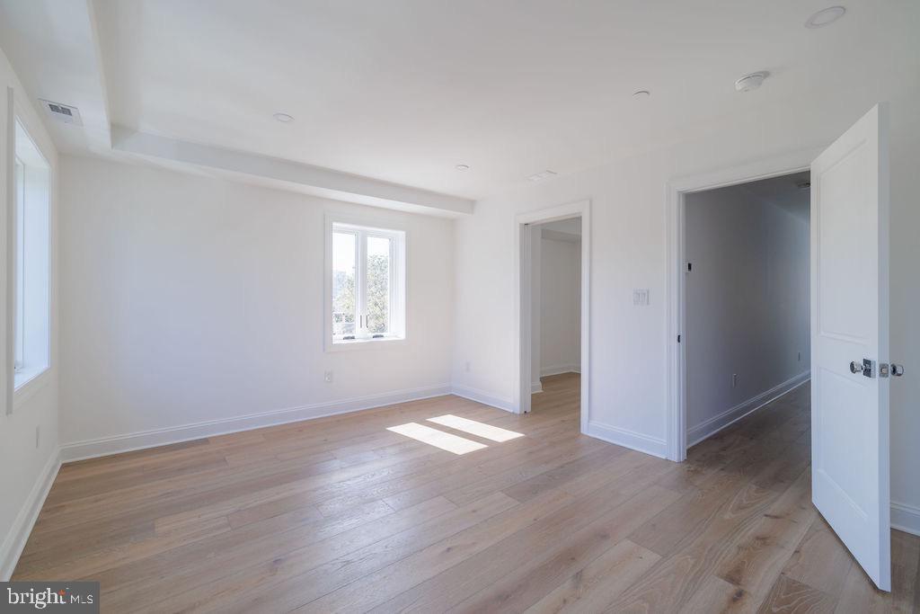 1200 Potomac Street Northwest Washington, DC 20007 - Photo 18 of 37 a view of an empty room with wooden floor and a window