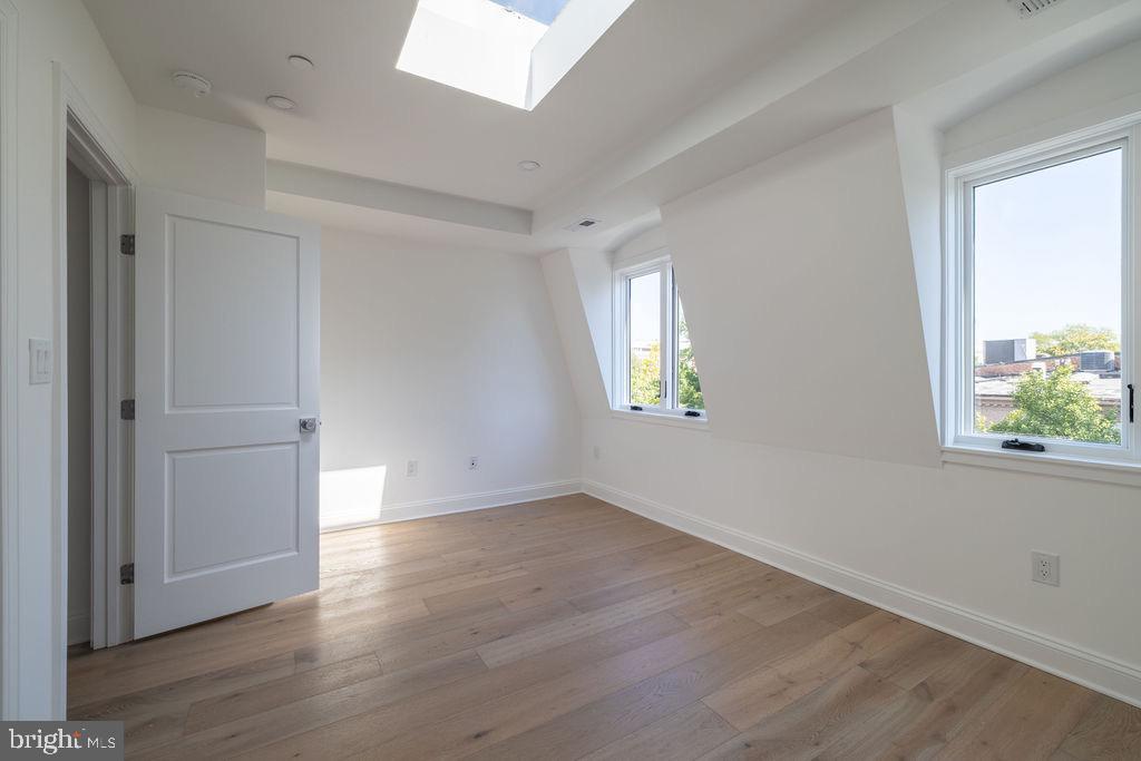 1200 Potomac Street Northwest Washington, DC 20007 - Photo 28 of 37 an empty room with wooden floor and windows