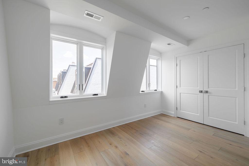 1200 Potomac Street Northwest Washington, DC 20007 - Photo 32 of 37 a view of empty room with wooden floor and fan