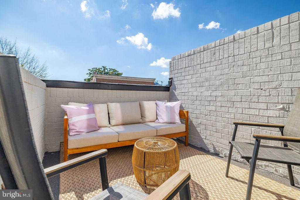 1200 Potomac Street Northwest Washington, DC 20007 - Photo 36 of 37 a view of a patio with couches and table and chairs with wooden floor