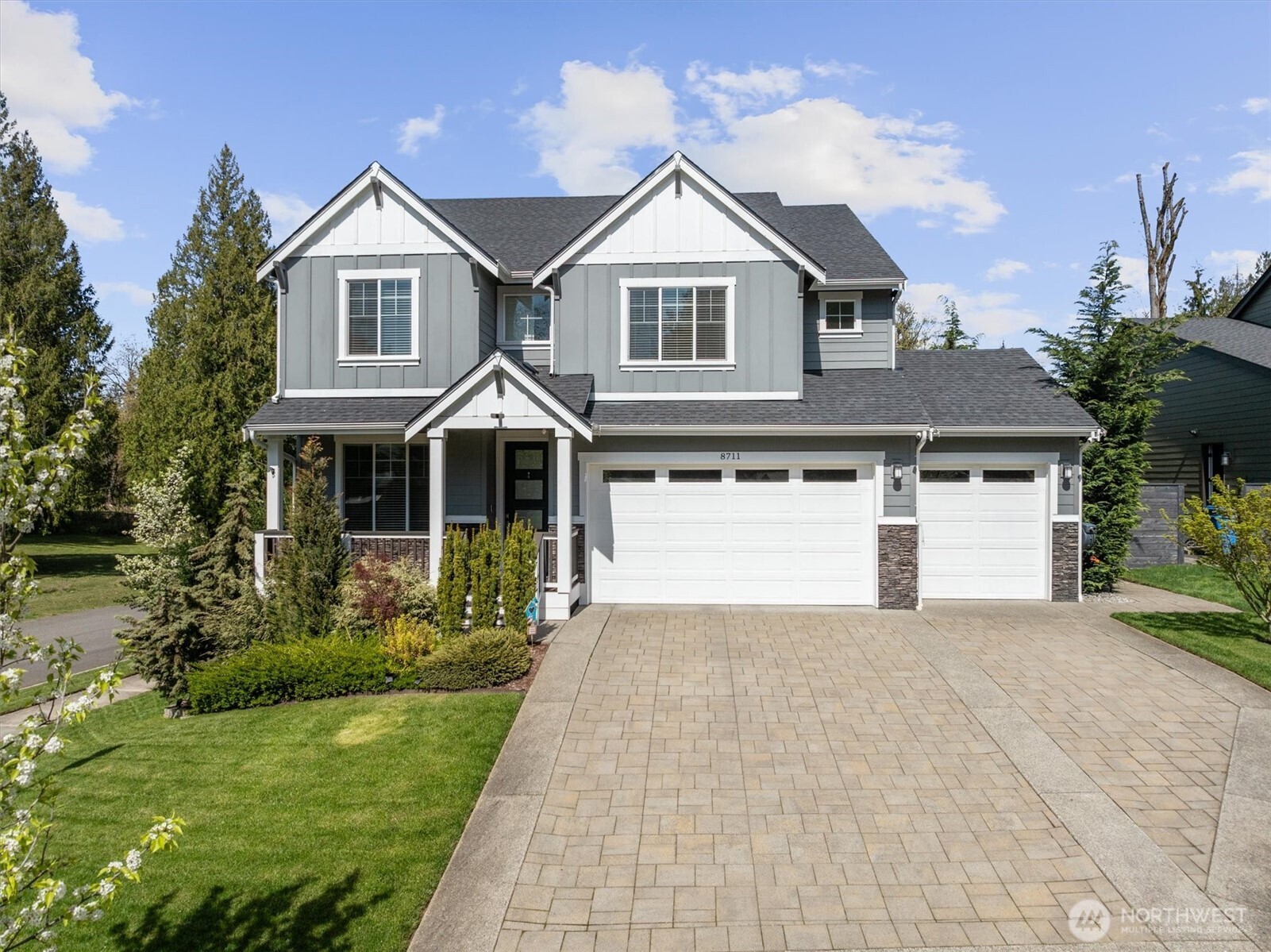 8711 27th Street East Edgewood, WA 98371 - Photo 1 of 40 a front view of a house with a yard and garage