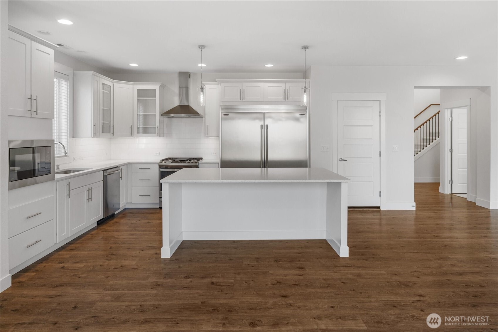 8711 27th Street East Edgewood, WA 98371 - Photo 13 of 40 a large kitchen with stainless steel appliances granite countertop a stove a sink and a refrigerator