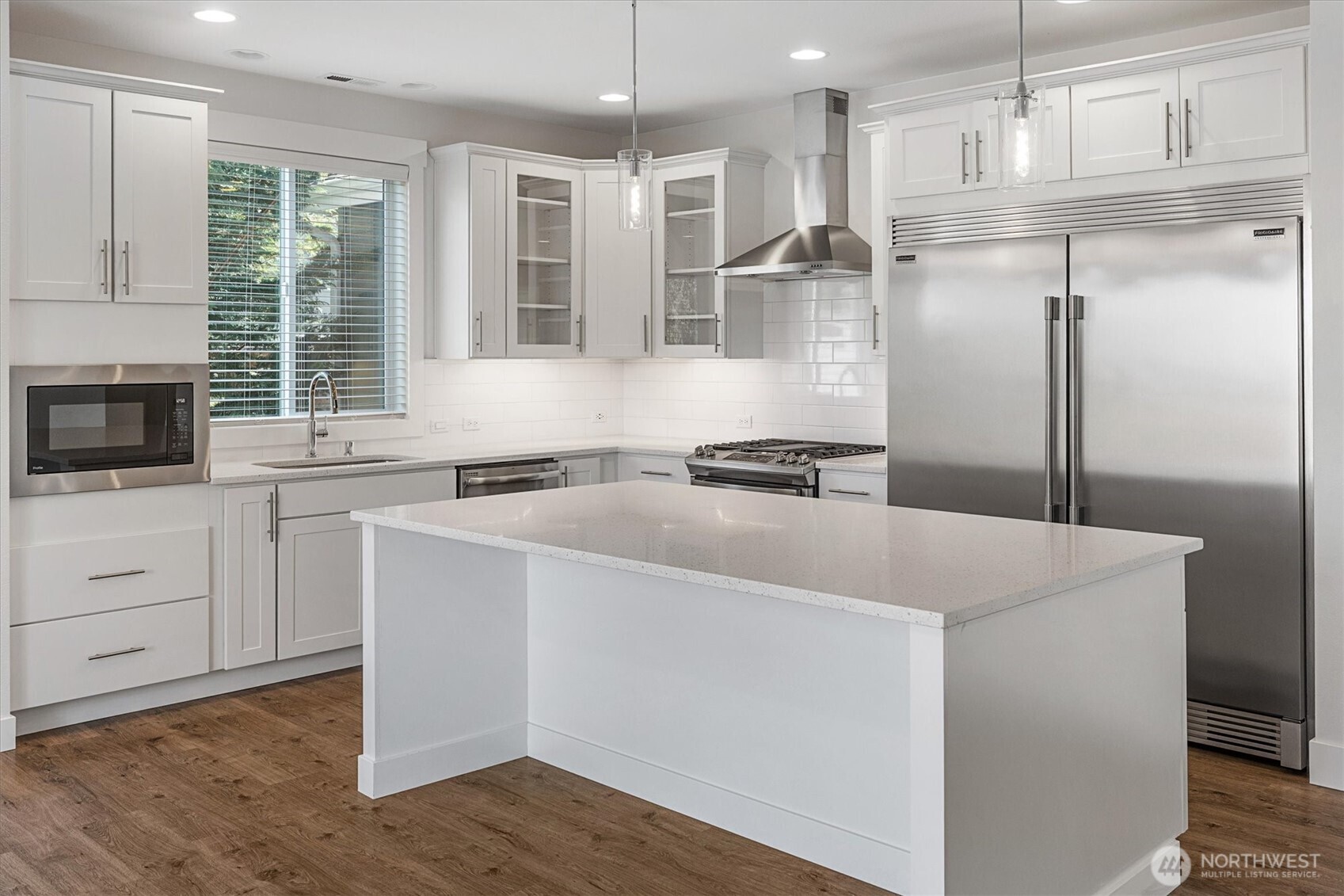 8711 27th Street East Edgewood, WA 98371 - Photo 14 of 40 a kitchen with a refrigerator a sink and cabinets