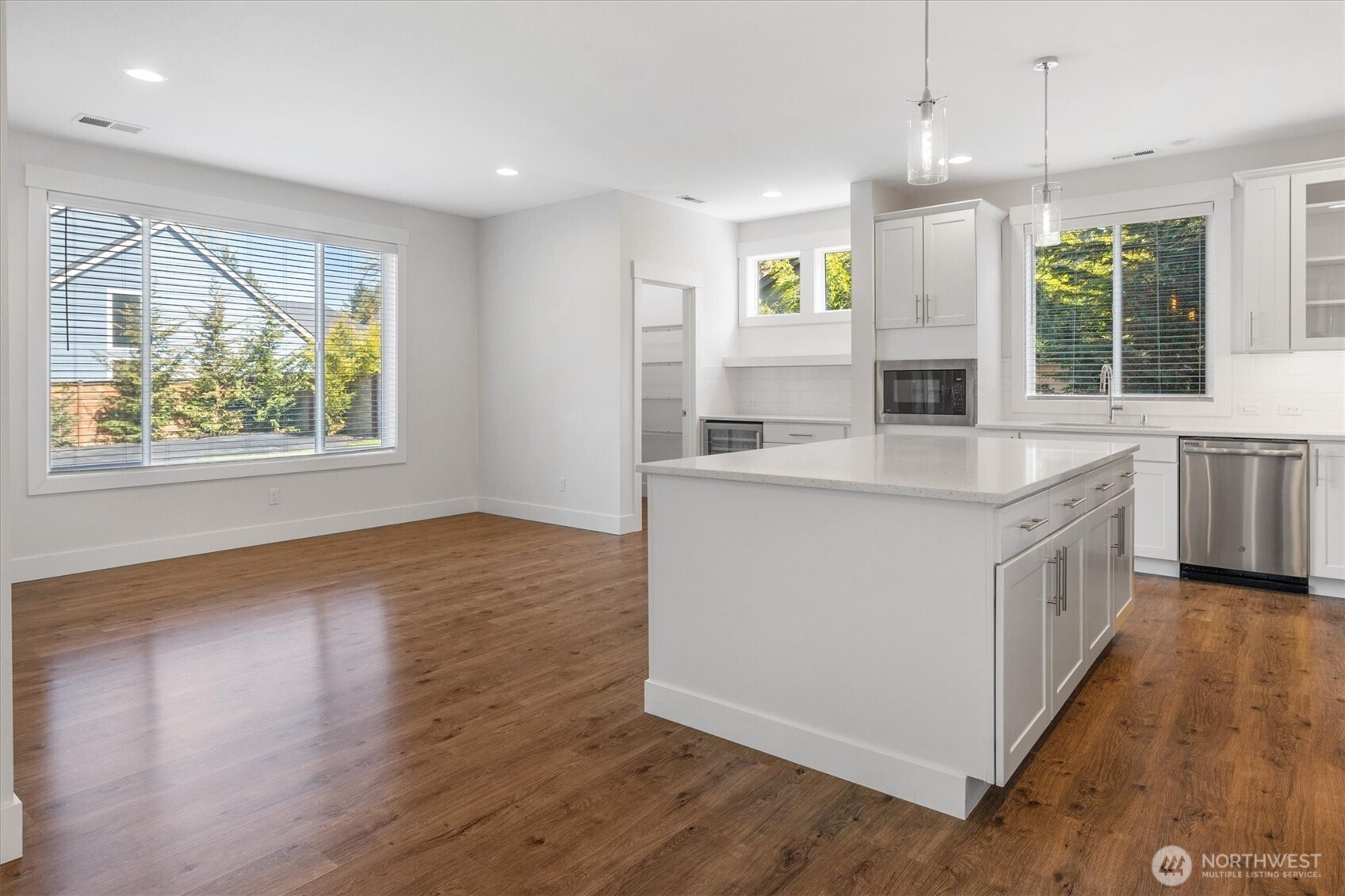 8711 27th Street East Edgewood, WA 98371 - Photo 16 of 40 a kitchen with wooden floors and windows
