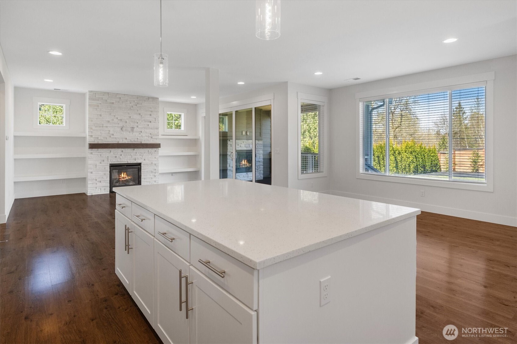 8711 27th Street East Edgewood, WA 98371 - Photo 19 of 40 a large kitchen with stainless steel appliances granite countertop a large counter top a stove and a wooden floors