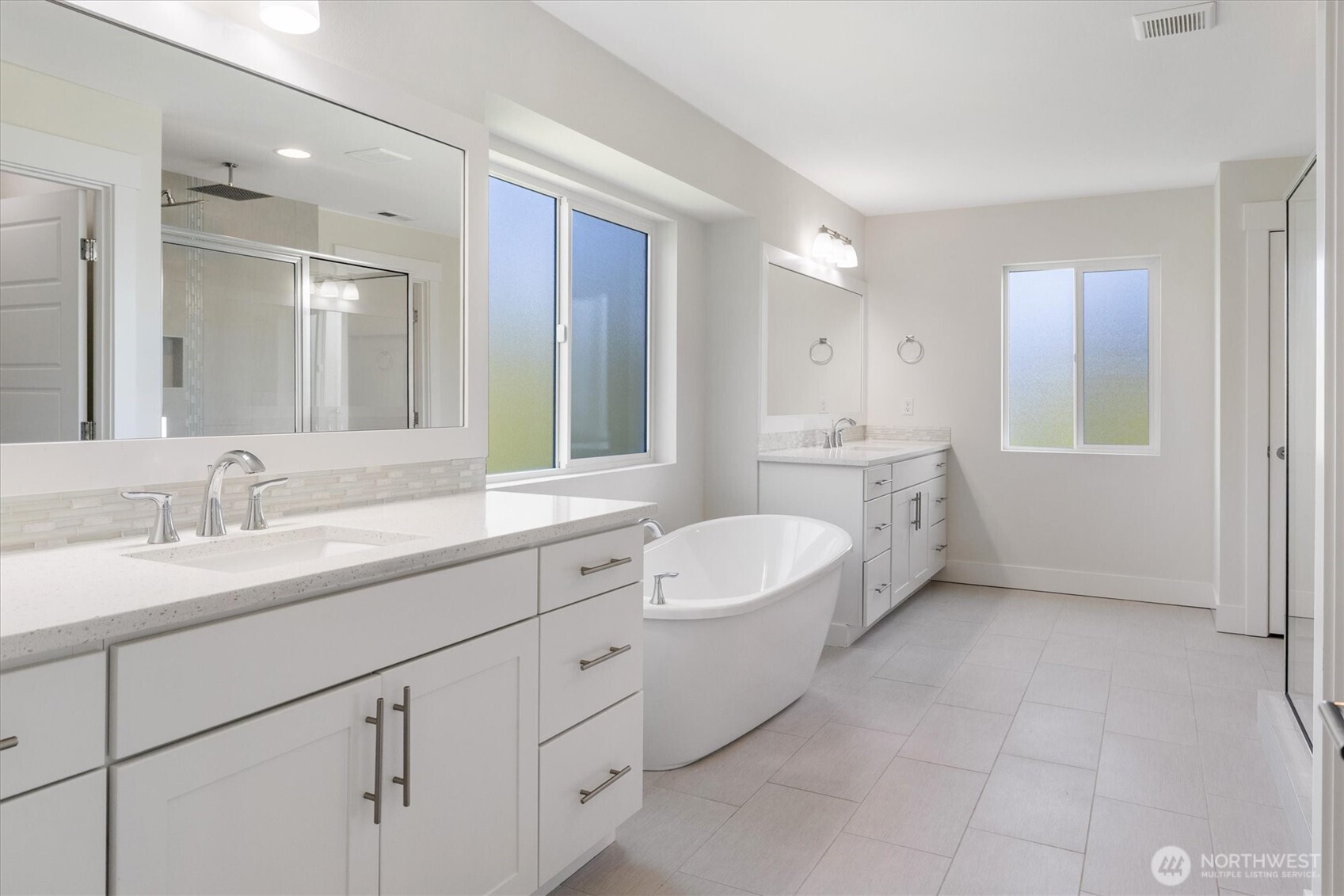 8711 27th Street East Edgewood, WA 98371 - Photo 24 of 40 a spacious bathroom with a granite countertop sink mirror and double