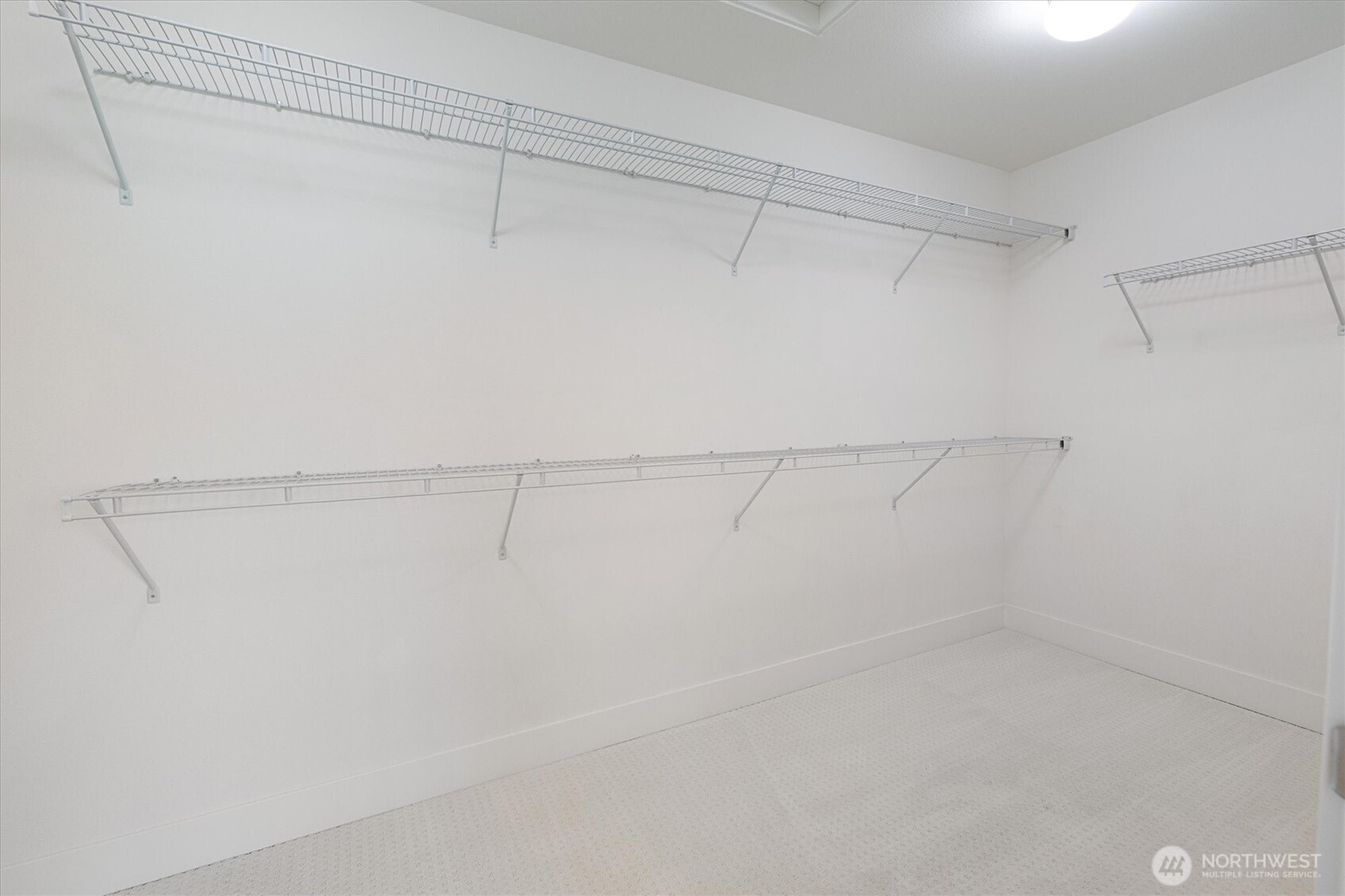 8711 27th Street East Edgewood, WA 98371 - Photo 26 of 40 a view of a room with racks on the wall