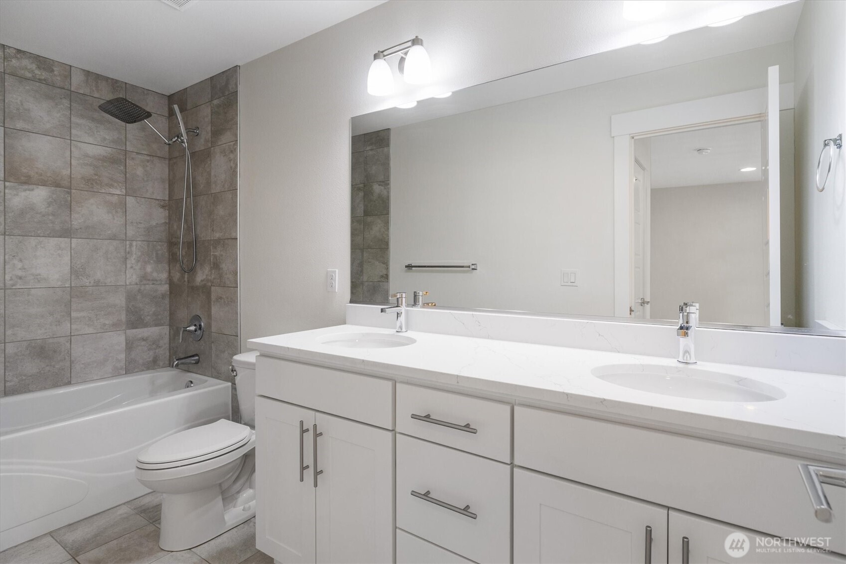 8711 27th Street East Edgewood, WA 98371 - Photo 29 of 40 a bathroom with a sink a toilet and shower