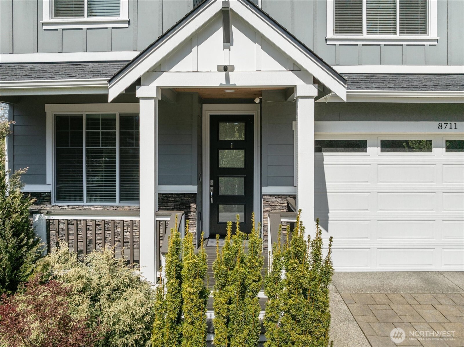 8711 27th Street East Edgewood, WA 98371 - Photo 3 of 40 a front view of a house with a lots of flowers in it