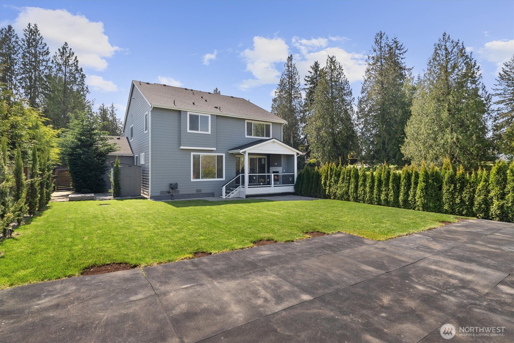 8711 27th Street East Edgewood, WA 98371 - Photo 33 of 40 a front view of a house with a garden and trees