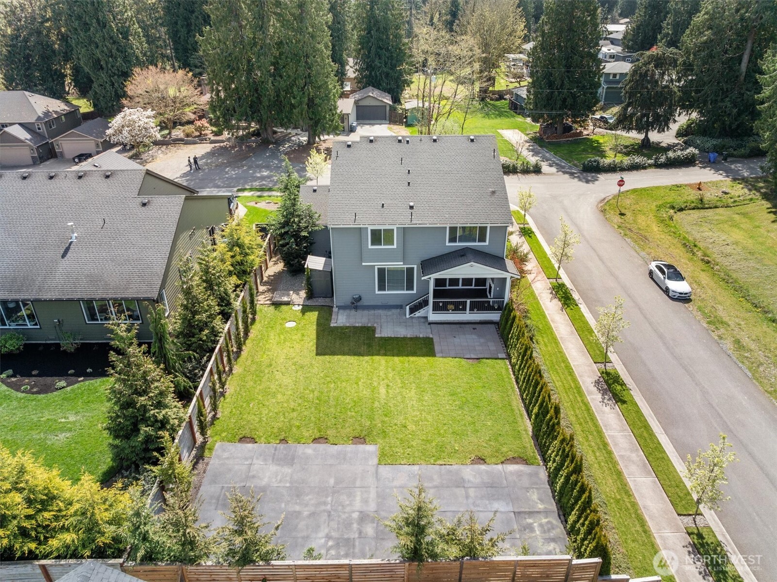 8711 27th Street East Edgewood, WA 98371 - Photo 36 of 40 an aerial view of a house with swimming pool and large trees