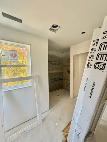 a view of a bedroom with wooden floor