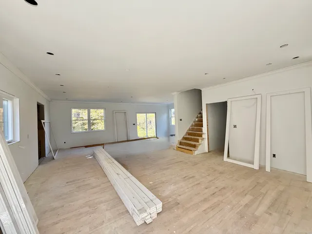 en empty room with windows and entrance