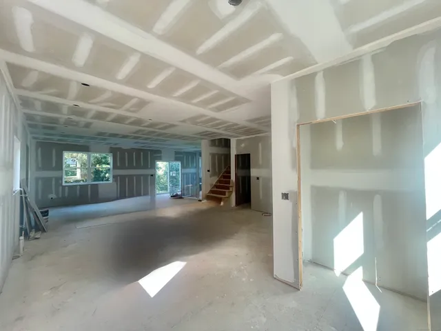a view of a big room with closet and windows