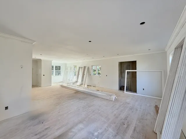 a view of empty room with wooden floor and cabinet