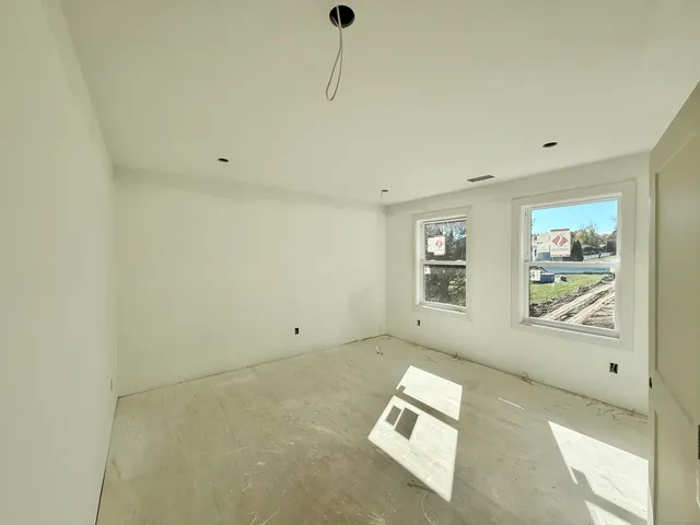 a room with a window and a wooden floor