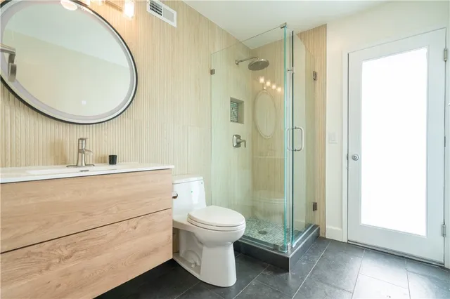 a bathroom with a toilet a sink and a mirror