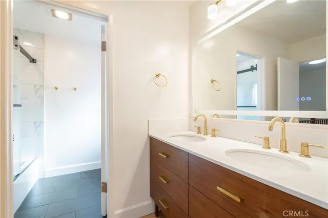 a bathroom with a granite countertop sink mirror and double