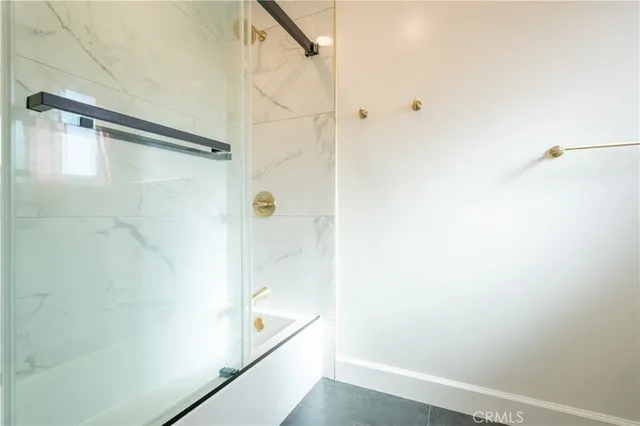 a bathroom with a shower and a glass door