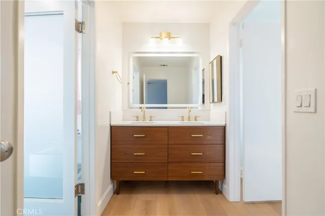 a bathroom with a double vanity sink mirror and