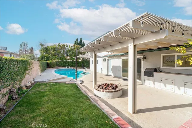 a view of a house with backyard and sitting area