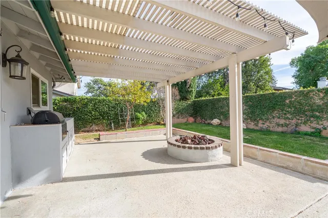 a view of a porch with furniture and garden