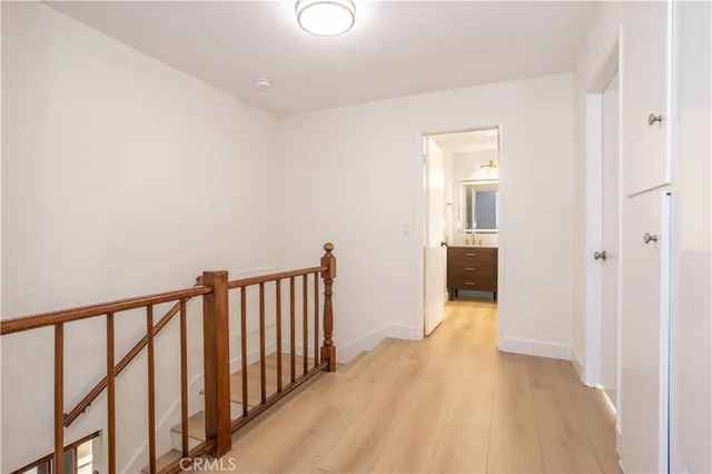 a view of hallway with wooden floor
