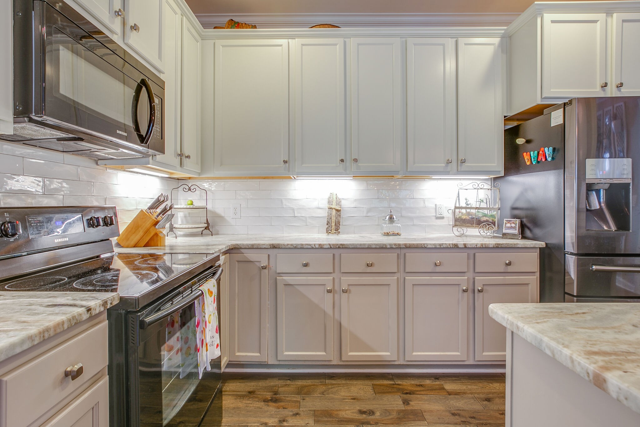 136 Ormesby Place Franklin, TN 37064 - Photo 20 of 41 a kitchen with stainless steel appliances granite countertop a sink stove and cabinets