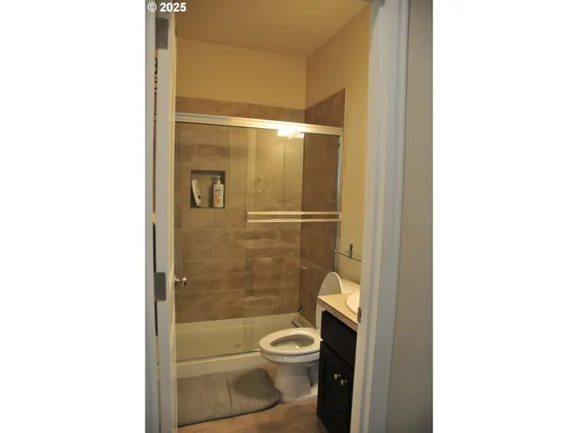 a bathroom with a toilet and a shower