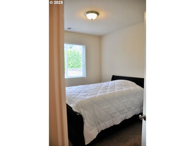 a bedroom with a bed and a window