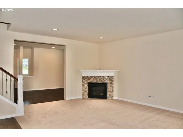a view of an empty room with a fireplace