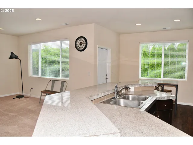 a kitchen with a sink and a large window