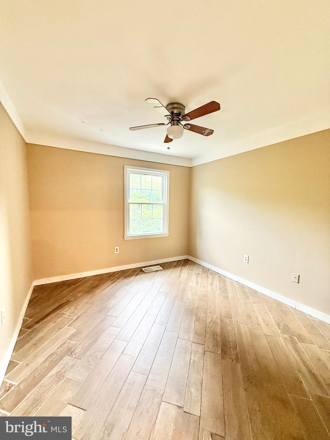 5439 Richenbacher Avenue Alexandria, VA 22304 - Photo 8 of 23 an empty room with wooden floor and windows