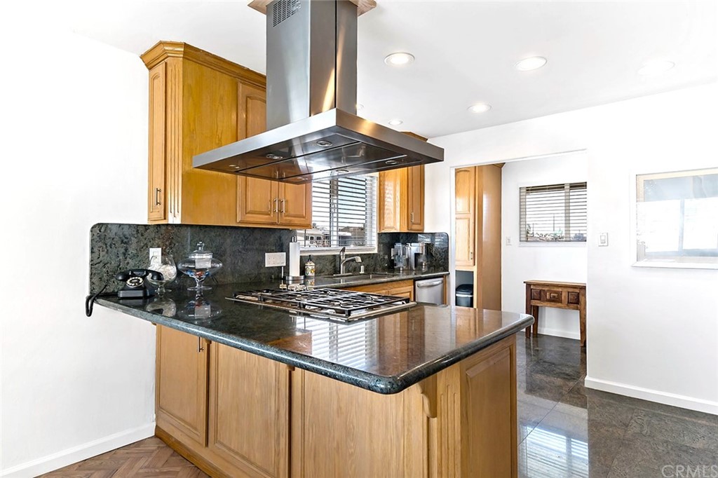 525 East 246th Street Carson, CA 90745 - Photo 12 of 41 a kitchen with stainless steel appliances granite countertop a sink a stove and cabinets