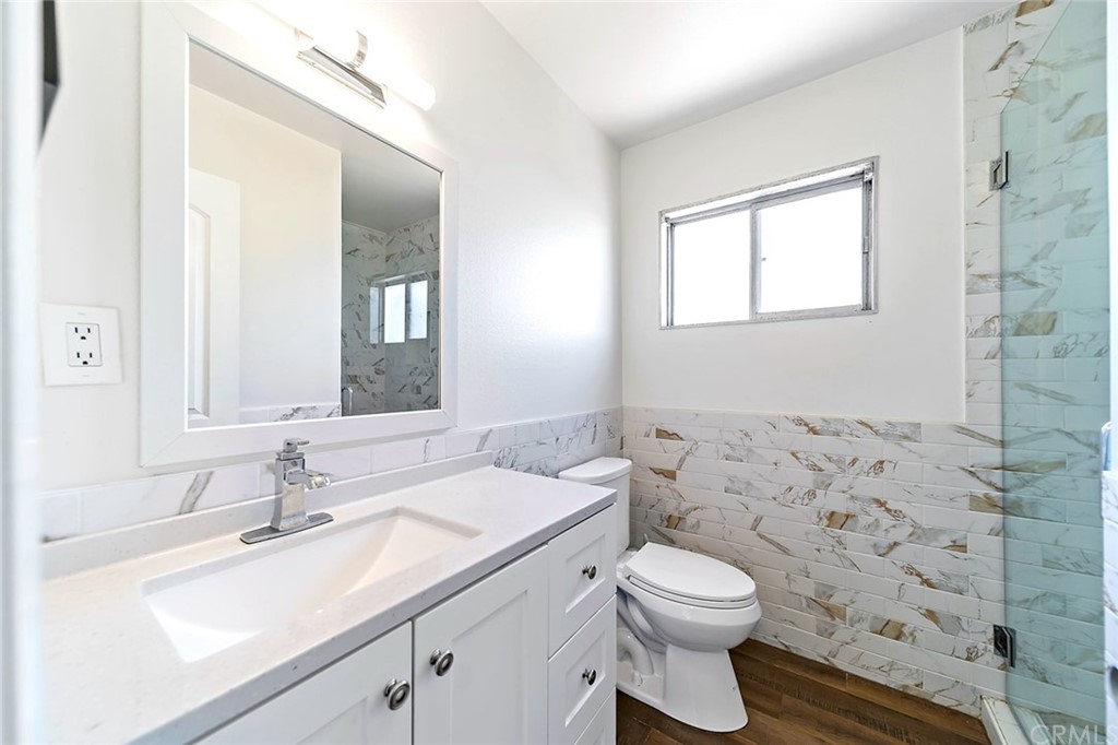 525 East 246th Street Carson, CA 90745 - Photo 25 of 41 a bathroom with a sink a toilet and a mirror