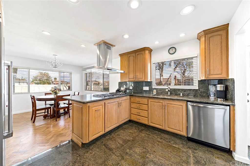 525 East 246th Street Carson, CA 90745 - Photo 7 of 41 a kitchen with stainless steel appliances granite countertop sink stove top oven and cabinets