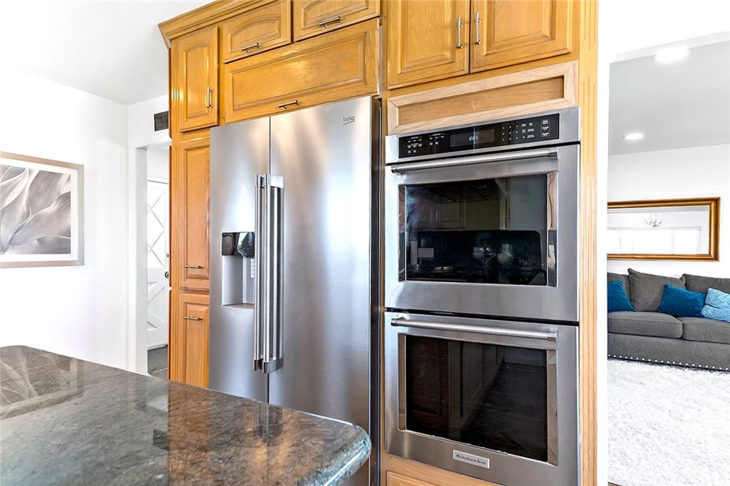 525 East 246th Street Carson, CA 90745 - Photo 10 of 41 a kitchen with a refrigerator stove and cabinets